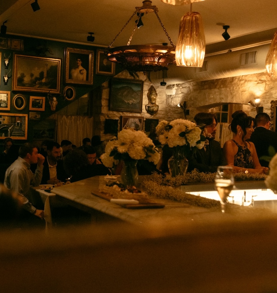 Atmospheric candlelight and guest interaction during an intimate wedding dinner at Alla Campagna.