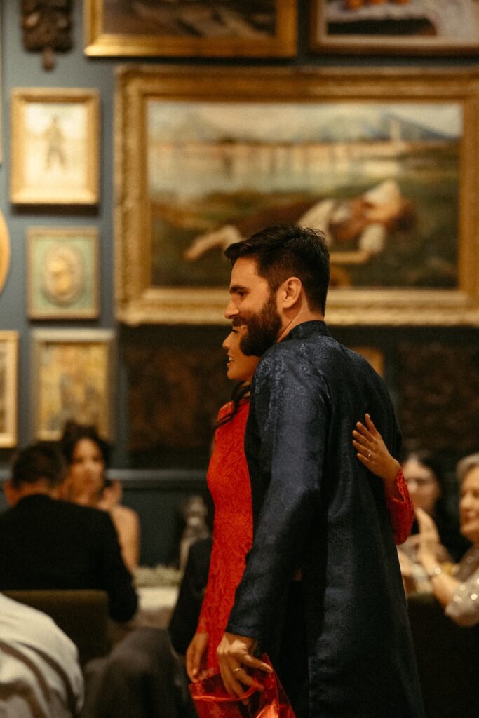 A bride wearing a traditional Vietnamese Ao Dai during her Fredericksburg wedding reception to honor family heritage.